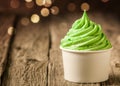 Tub of twirling creamy green Italian ice cream