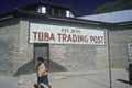 Tuba Trading Post sign painted on adobe brick wall of building