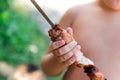 Tubby boy with pleasure eats a shish kebab. Camping. Healthy nutrition and diet. Royalty Free Stock Photo