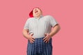 Tubby man laughs happily, with his hands on belly, expresses positive emotions. Royalty Free Stock Photo