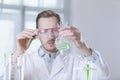 The tube and flask in the hands of the scientist