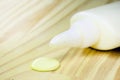 Tube of glue dripping drop on wooden board, carpentry concept, spot focus