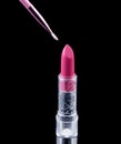 Tube of lipstick with a brush make-up on black Royalty Free Stock Photo