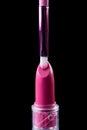 Tube of lipstick with a brush make-up on black Royalty Free Stock Photo