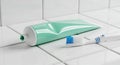 Toothpaste Tube And Toothbrush On White Tiled Surface Royalty Free Stock Photo