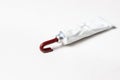 A tube of red paint on a white background. Royalty Free Stock Photo