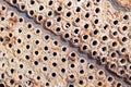 Tube sheet or plate of heat exchanger or boiler closeup texture macro diagonal background full of insoluble hard mineral deposits