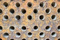 Tube sheet plate of industrial gas compressor heat exchanger or boiler closeup texture macro full of cracks insoluble Royalty Free Stock Photo