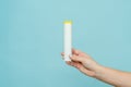 Tube for vitamins, pills in hand. Packaging. Mockup Royalty Free Stock Photo