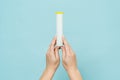 Tube for vitamins, pills in hand. Packaging. Mockup Royalty Free Stock Photo