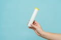Tube for vitamins, pills in hand. Packaging. Mockup Royalty Free Stock Photo