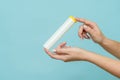 Tube for vitamins, pills in hand. Packaging. Mockup Royalty Free Stock Photo