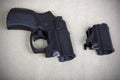 Tubeless doubly charged traumatic pistol and holder. Image with