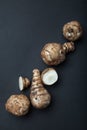 The tubers of the organic unpurified topinambur Jerusalem artichoke, Helianthus tuberosus, sunroot, sunchoke on black background Royalty Free Stock Photo