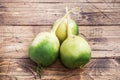 Tubers of raw green radish on a wooden background