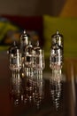 Tubes for electric guitar amplifier ECC83 - 12AX7 and EL84 types. Vacuum electron tubes closeup with glass reflections.