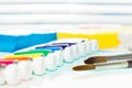 Tubes of paint and brushes laying on the table Royalty Free Stock Photo