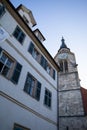 TUBINGEN/GERMANY-JULY 29 2018: Around the Collegiate Church, Square with fountain in front of cathedral. The sky is clear without