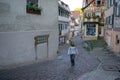 TUBINGEN/GERMANY-JULY 30 2019: A Moslem young girl walking on the path near Nice old half-timbered fachwerk houses