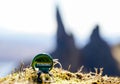 A Tuborg Bottle cap in front of the Old Man of Storr in Scotland. Royalty Free Stock Photo