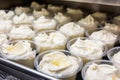 tubs filled with cream cheese ready for packaging