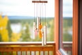 tubular wind chimes made of copper hanging from a wooden beam Royalty Free Stock Photo