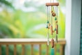 tubular wind chimes made of copper hanging from a wooden beam Royalty Free Stock Photo