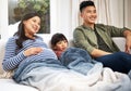 Tucked in to a good movie. a family watching television together at home. Royalty Free Stock Photo