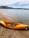 Tucktec folding kayak boat in orange colour on a bay of lake Hume,