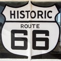 Tucumcari NM / United States - July 18, 2016: giant Route 66 Highway symbol painted sign on a defunct and abandoned gas station sh