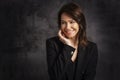 tudio portrait of beautiful brunette haired woman against isolated dark background