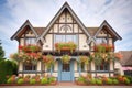 tudor house front gable with hanging flower baskets