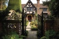 Tudor House With Garden And Stone Fountain Visible Through Iron Gate
