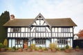 tudor house with halftimbered walls and steeply pitched roof