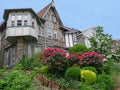 Tudor style stone houses with gables and lush hillside front gardens