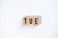 ` TUE ` text made of wooden cube on White background