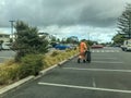 Auckland Council worker carrying black garbage bag