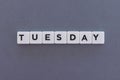 Tuesday word made of square letter word on grey background