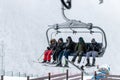 Tufandag, Gabala - Azerbaijan: 30 January 2021. Happy friends on ski lift chair enjoying winter ski vacations in Royalty Free Stock Photo