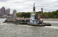 Tug and barge of scrap metal on East River NYC