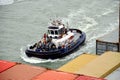 Tug boat assisting to the container ship. Royalty Free Stock Photo