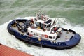 Tug boat assisting to the container ship. Royalty Free Stock Photo