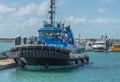 Tug Boat with blue cabin, tied up at Mackay Harbour, Australia