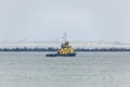 Tug boat with coast line in the background Royalty Free Stock Photo