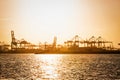 Tug boat in harbor with cranes Royalty Free Stock Photo