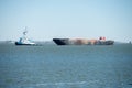 Tug boat and large container ship in chaleston sc Royalty Free Stock Photo