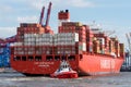 Tug boat maneuvers large container boat in Hamburg Royalty Free Stock Photo