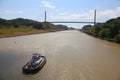 Tug boat sailing towards the Centennial Bridge, on the Culebra Cut, Panama Canal