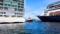 Tug boat and cruise ships Royalty Free Stock Photo