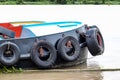 Tug boat with tires fender on the river